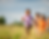 Group of joyful children running through a grassy field on a sunny day, symbolizing youth empowerment, freedom, and connection to nature—aligned with Essential Earth Futures' mission to inspire the next generation of environmental leaders