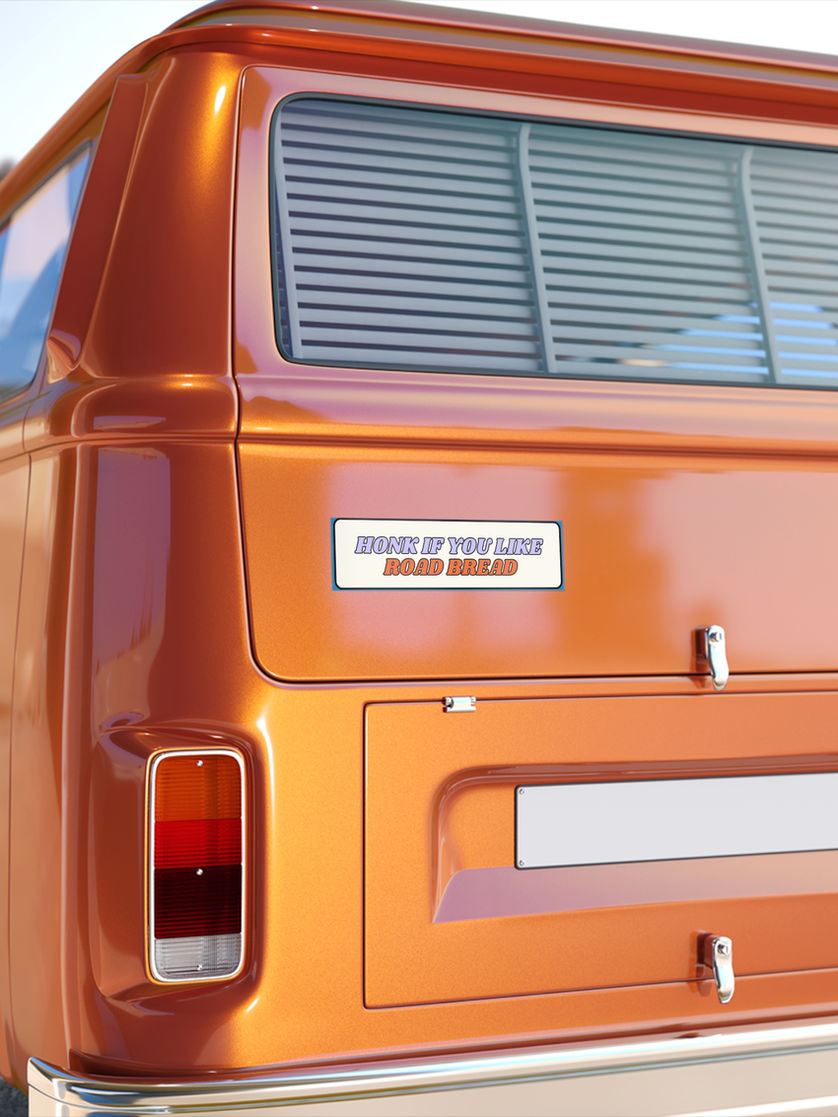 Orange vintage van with 'HONK IF YOU LIKE ROAD BREAD' bumper sticker