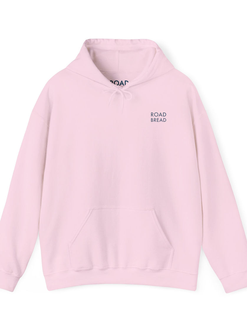 Front of soft pink hoodie with minimal Road Bread logo detail
