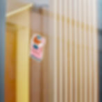 Humorous baguette box sticker adhered to a glass window, adding a playful bakery twist to any surface.