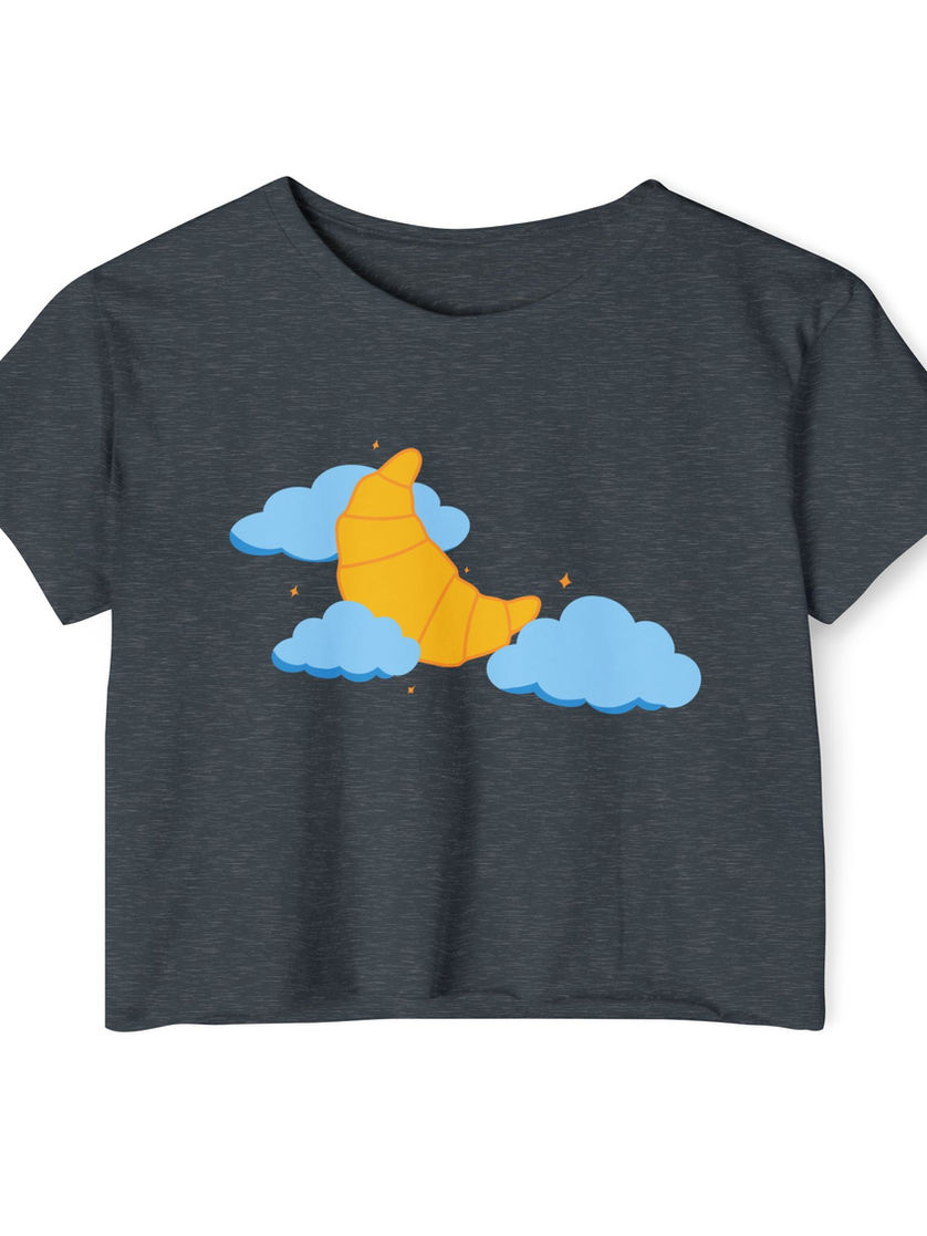 A heather blue cropped tee with the playful croissant and cloud illustration on the front.