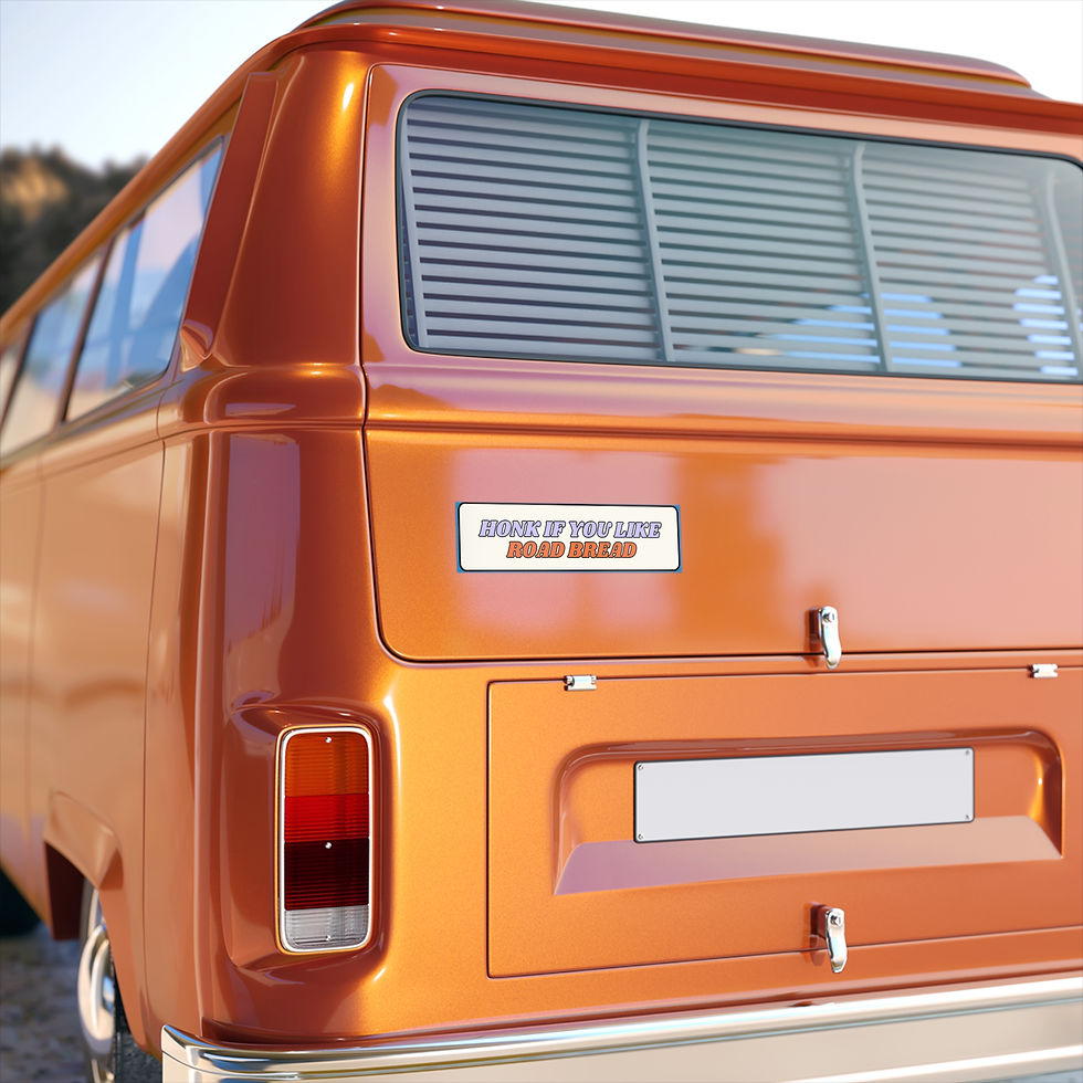 Orange vintage van with the “Honk If You Like Road Bread” bumper sticker centered on the rear hatch.