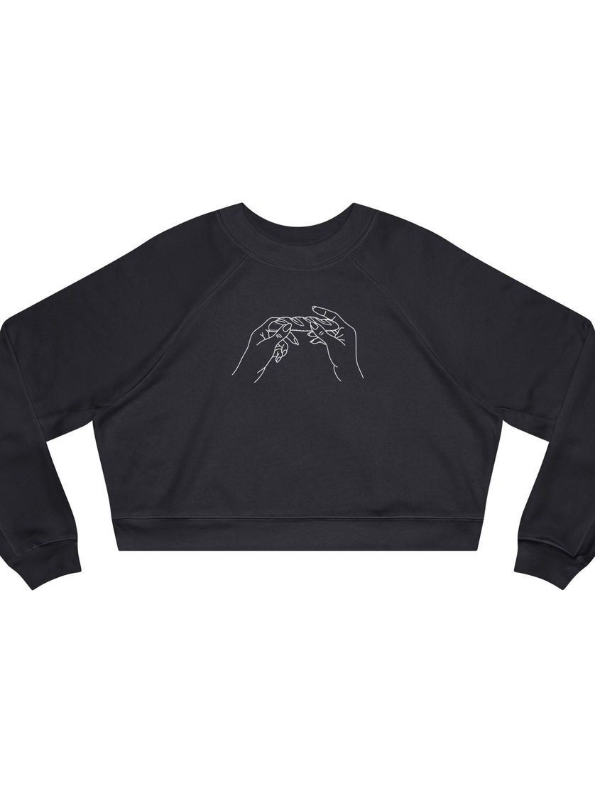 Dark gray cropped sweatshirt featuring a hand-drawn white line art of two hands rolling a baguette like a blunt,