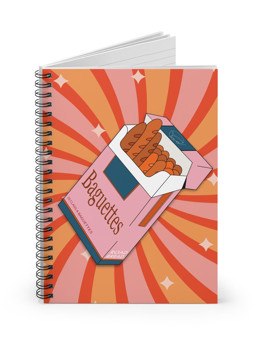n): Spiral notebook with a retro pop art cover featuring a satirical food design—pink baguette cigarette box on a starburst