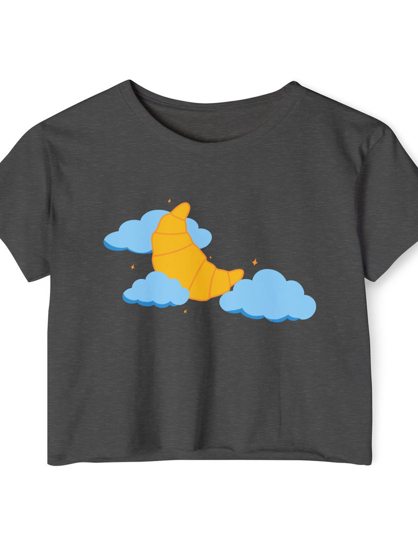 A dark gray crop tee adorned with a dreamy graphic of a croissant shaped like a crescent moon in the sky.