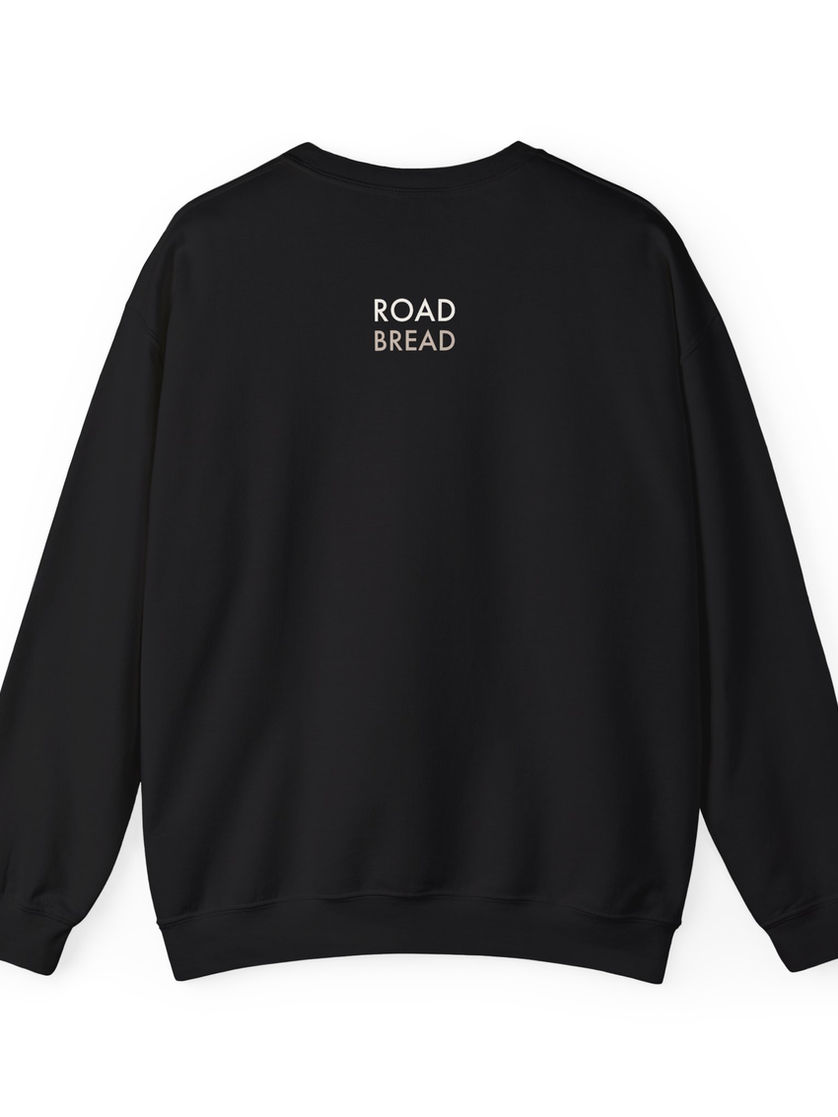 Black sweatshirt with Road Bread text on the back, fashionable clothing item.