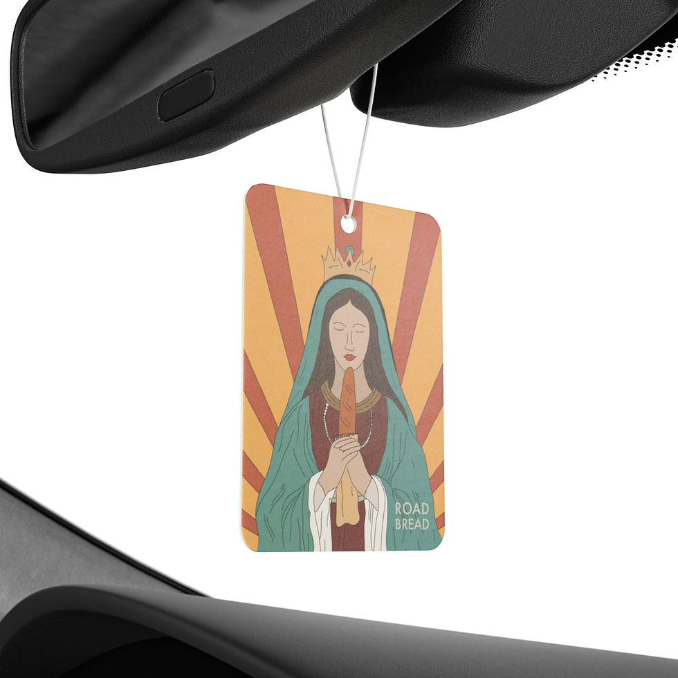 Air freshener hanging from a car mirror with playful religious design