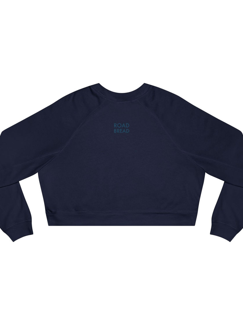 Back of blue cropped sweatshirt with Road Bread logo placed between shoulders.