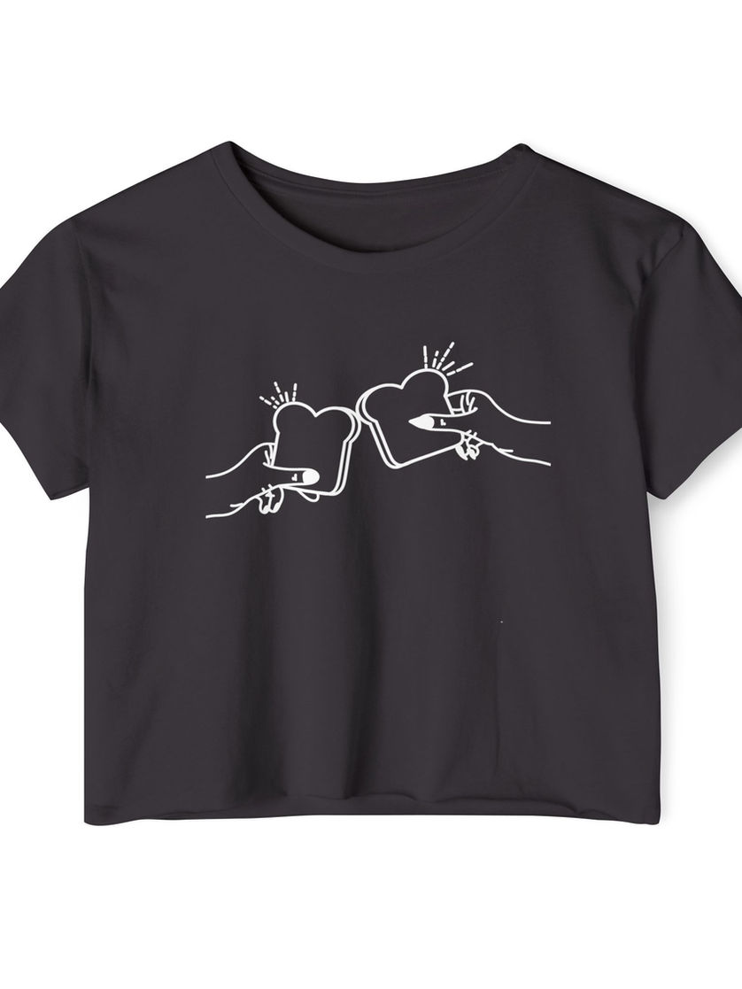 Black cropped tee with white line-drawing of two hands clinking toast slices in a cheers gesture.