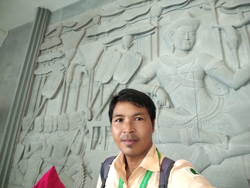 Man with lanyard against ancient stone carving