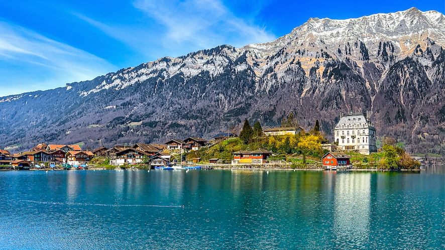 View of the beautiful peninsula of Iseltwald with Swiss Alps in the background.