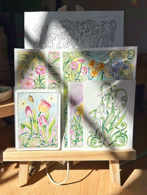 Spring themed watercolour paintings on a wooden easel