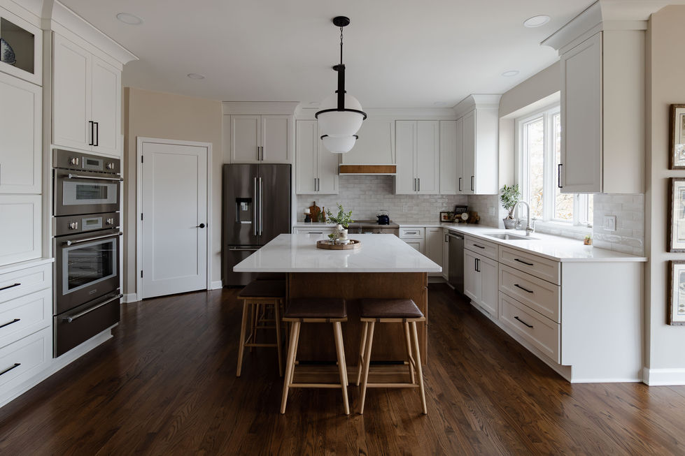 a kitchen with white cabinets and a stainless steel refrigerator