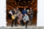 a band plays in the large well lit barn
