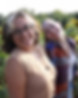 two young girls smile and pose in a sunflower field