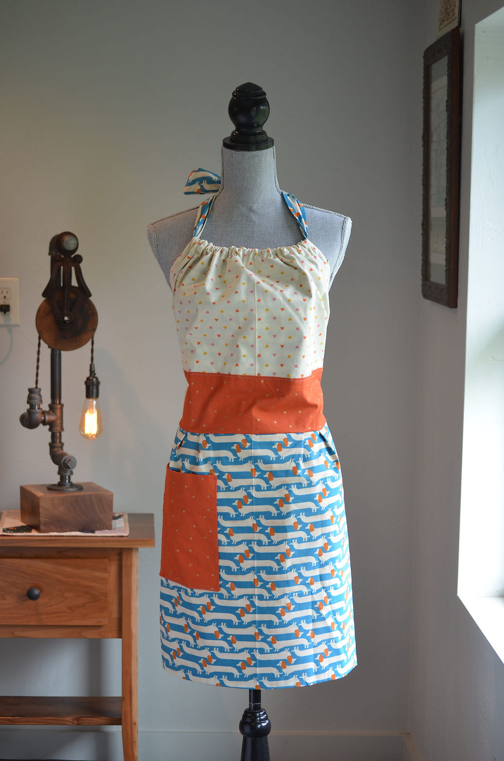 Reversible Apron with Cream colored top and blue with wiener dogs on bottom