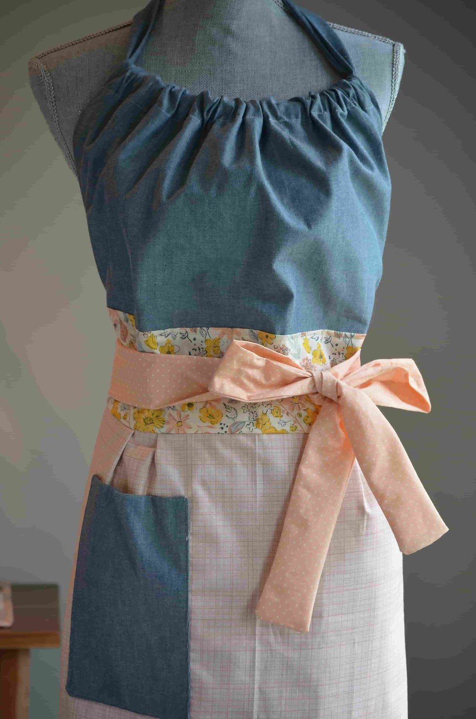 Thumbnail: Close up of waist straps tied in the front with a bow
