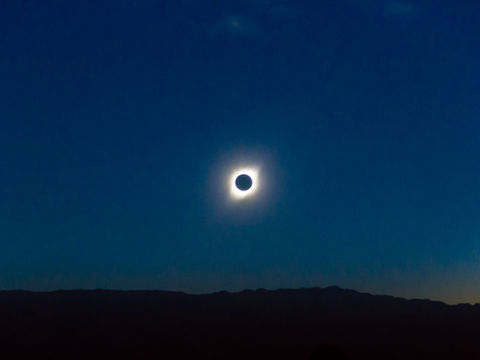 Total solar eclipse over Mallorca with the sun’s corona visible above the Tramuntana mountains