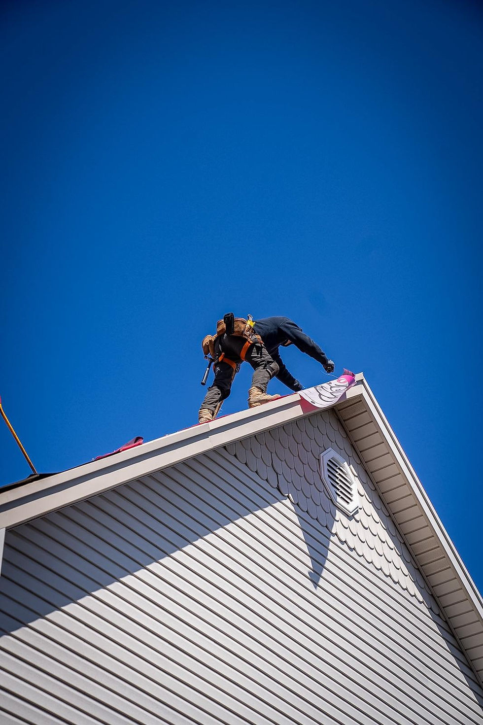 Eye-level view of a residential roof with missing shingles