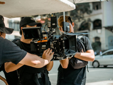 Film crew operating a RED camera on a city street