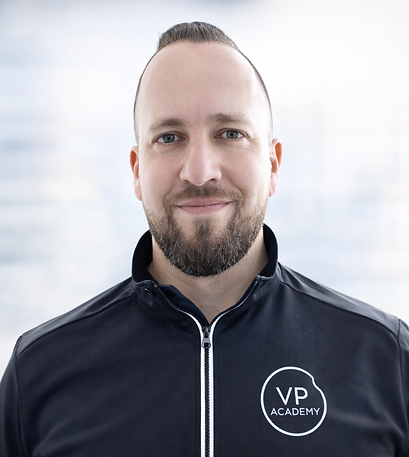 Confident professional headshot in navy jacket.png