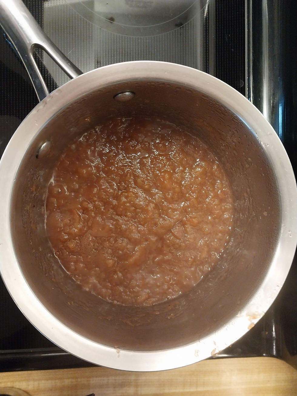 Rhubarb boiling on stove in a saucepan.