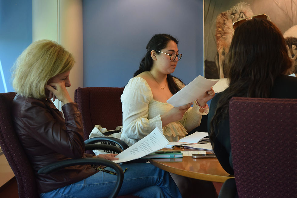 Neena Govea reading over her evidence while handing it out during the meeting. (Photo by Arlenis Marmolejos)
