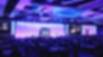 Bronkar Lee delivering a keynote to a large audience
