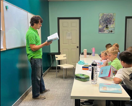 Teacher engaging a child in a fun Russian language lesson at Limpopo School, Oakville