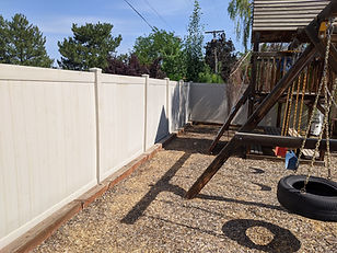 completed off-white vinyl fence with playground side view