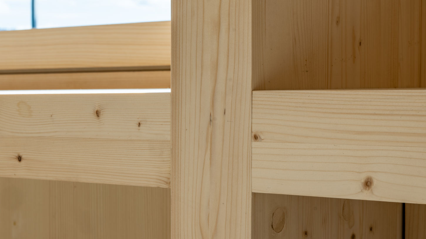 Nahaufnahme einer stabilen Holzpfosten-Konstruktion im Innenbereich.