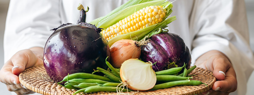 a-woman-holds-a-plate-with-eggplant-onion-corn-a-2023-11-27-04-48-06-utc.jpg