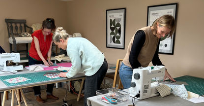 Students working on beginner's sewing projects