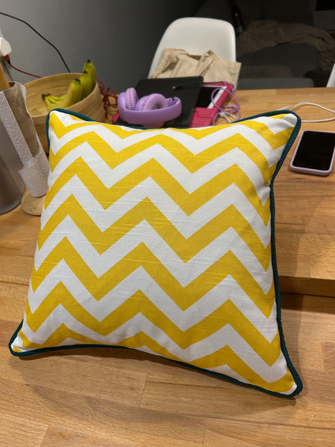 Beautiful handmade cushion made in our sewing class, with contrasting piping.