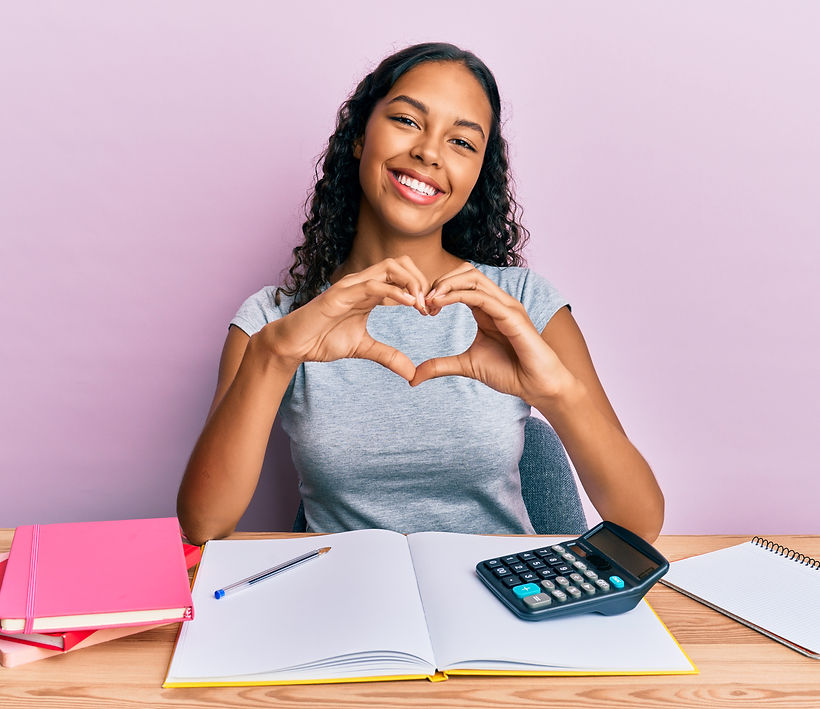 Young african american girl accountant working at the office smiling in love doing heart s
