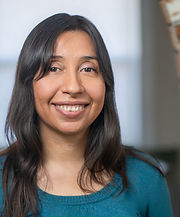 Headshot Reveca Torres. Brown skinned woman with long brown hair