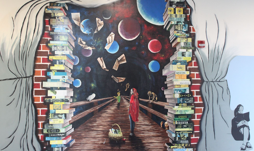 Painting of a girl walking through space with books standing tall on both her sides. The mural is located outside the Media Center and is one of the first Watauga High School students see upon arrival.