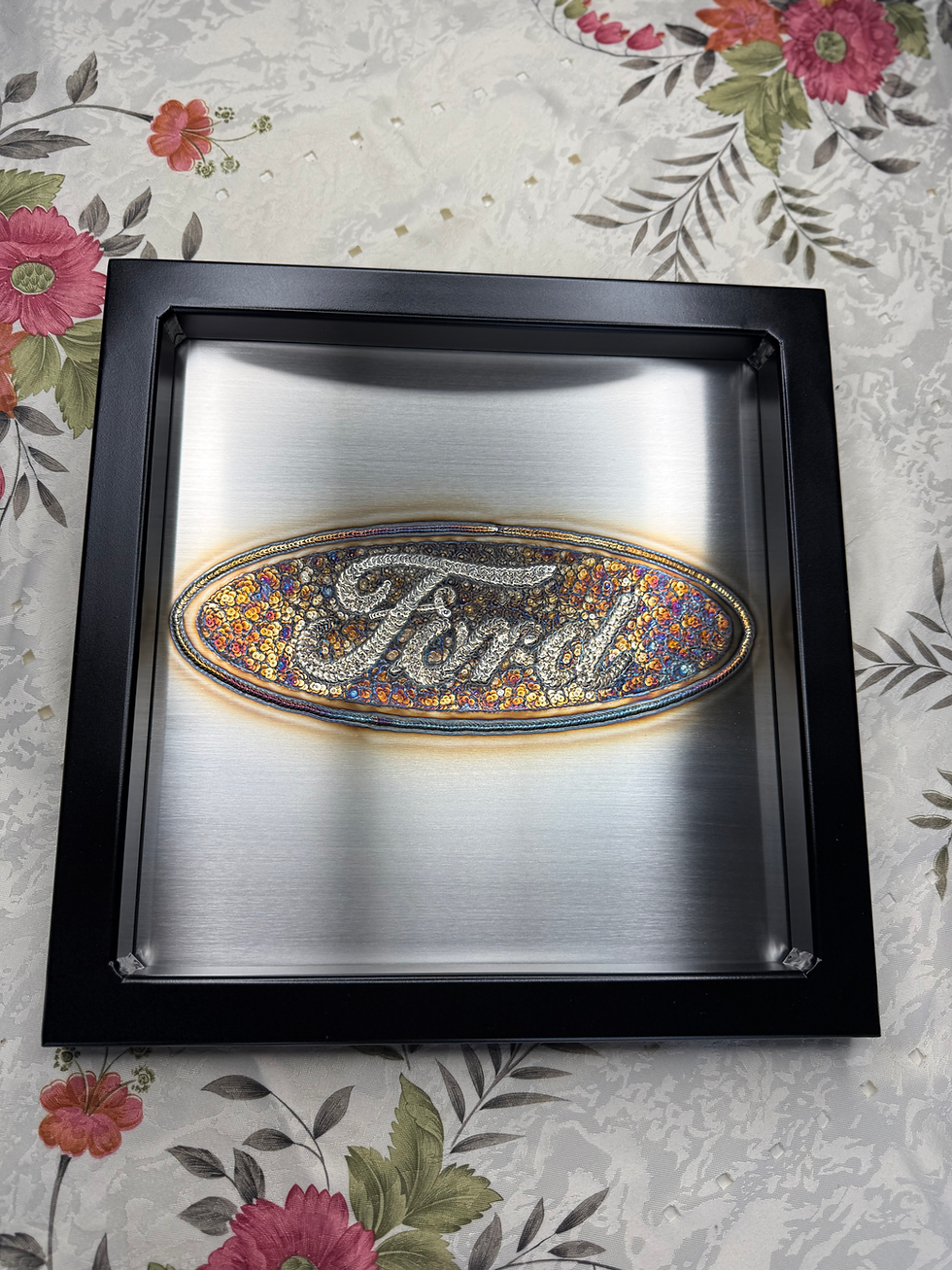 colorful Ford logo in tig weld art framed in black painted tubing front view