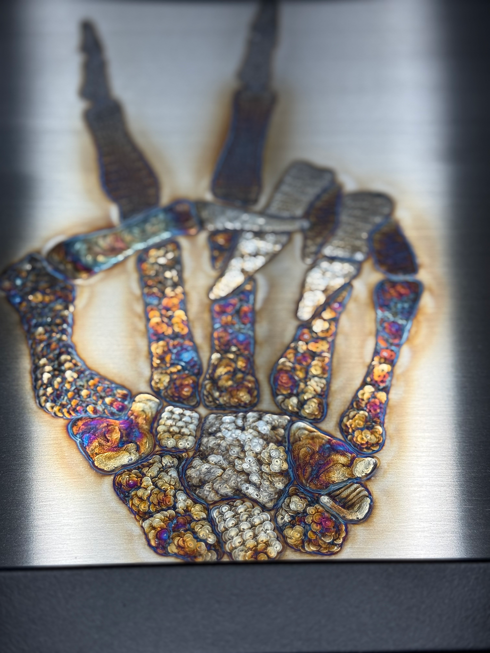 Thumbnail: Skeleton hand bones giving peace symbol with index and middle finger unique tig welding linework for each bone close up lower
