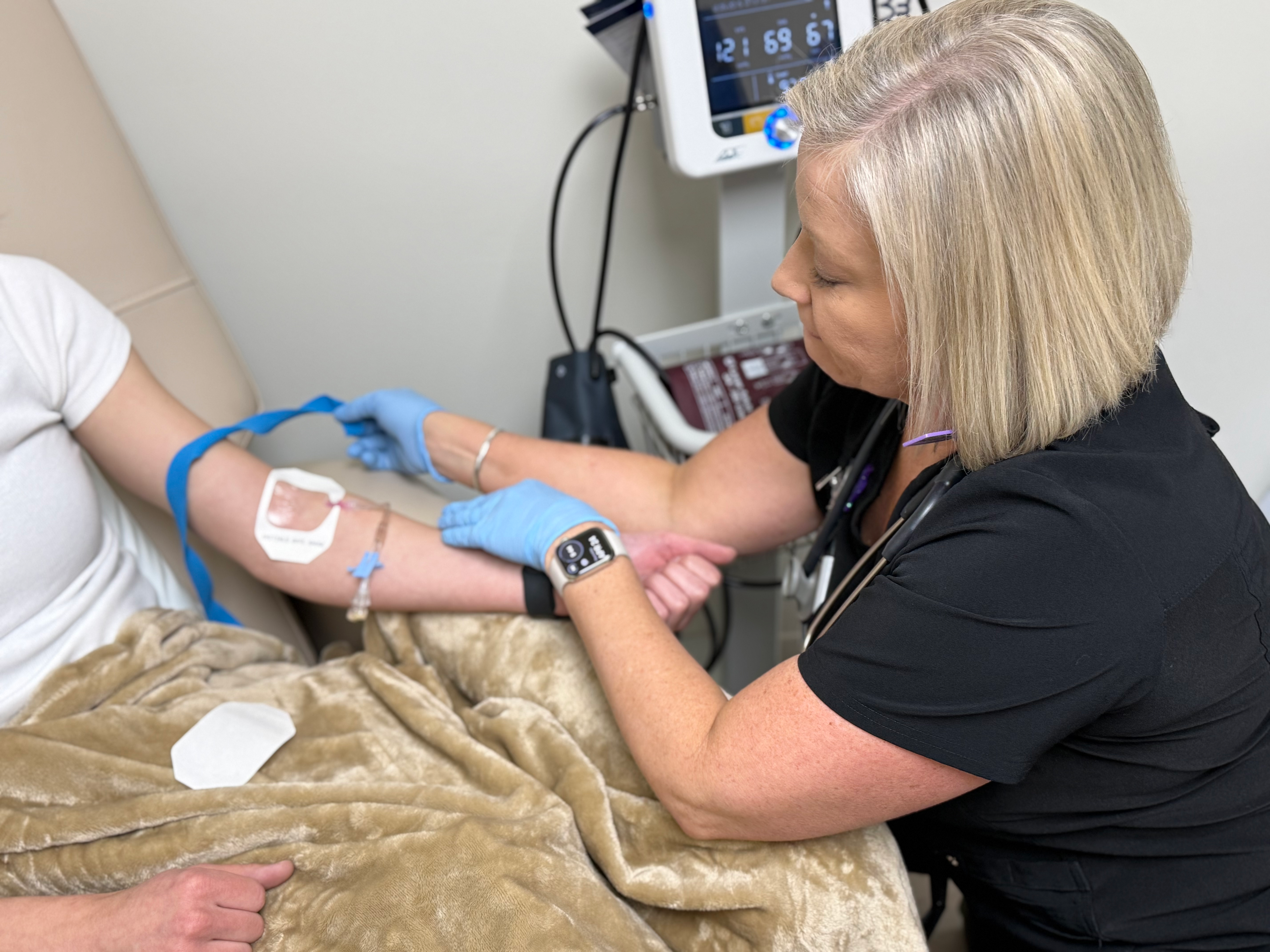 nurse prepping patient for infusion