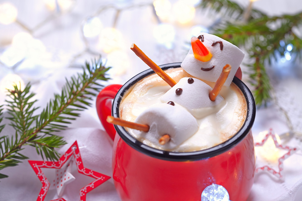 Marshmellow snowman floating in cup