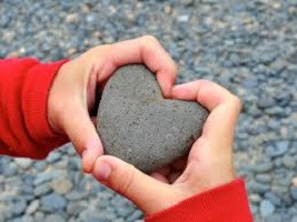 Heart shaped stone in child's hands
