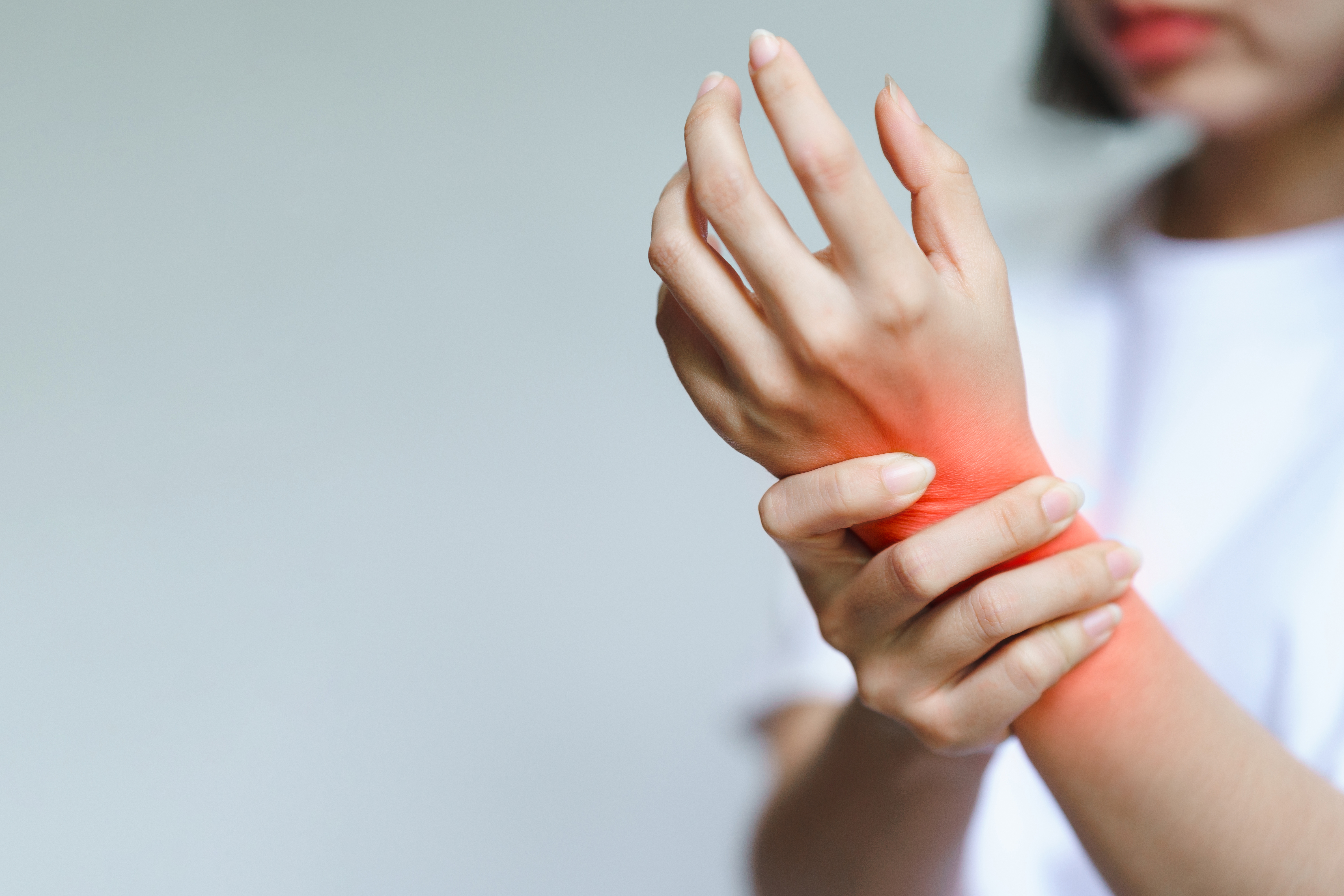 person holding wrist in pain