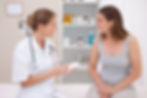 doctor writing prescription for female patient