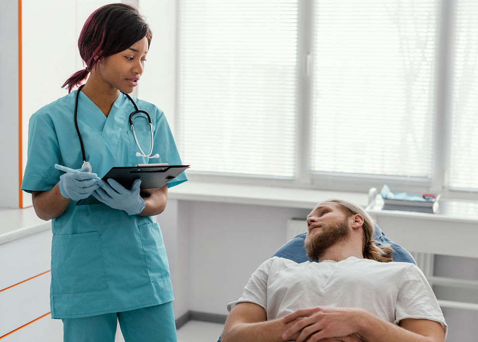 man laying on bed in clinic talking to nurse