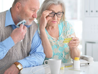 senior couple looking at medication information