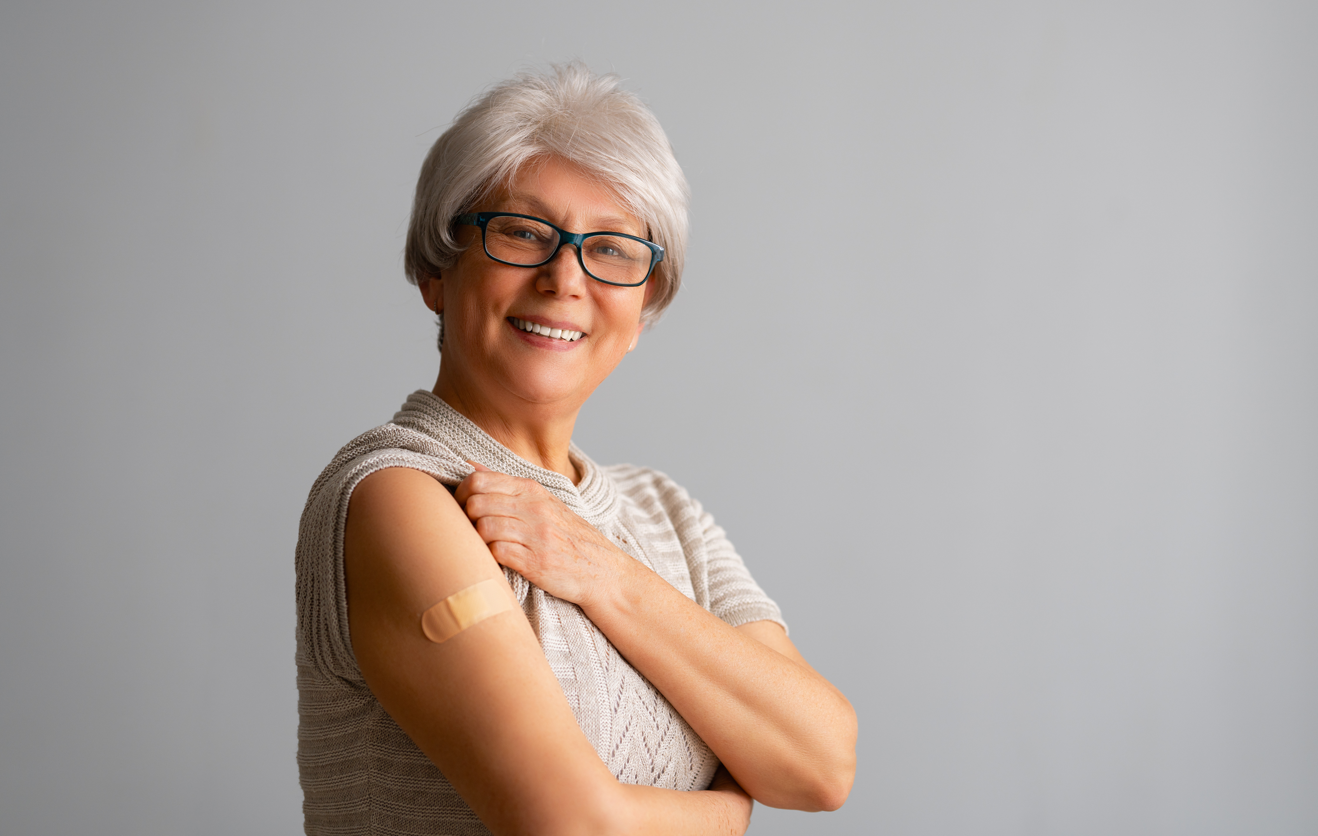 smiling woman with bandaid on arm