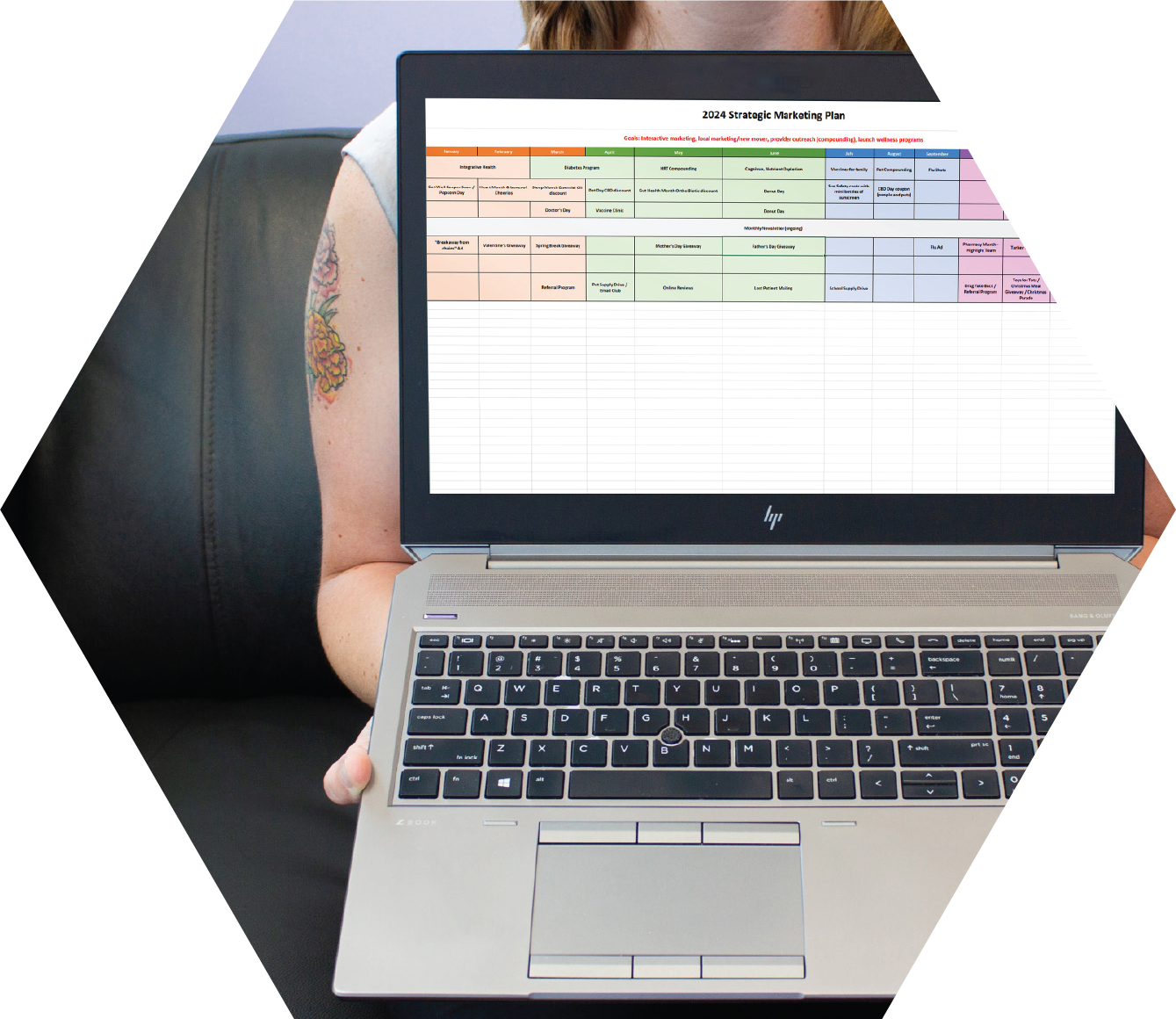woman holding computer with strategic marketing plan