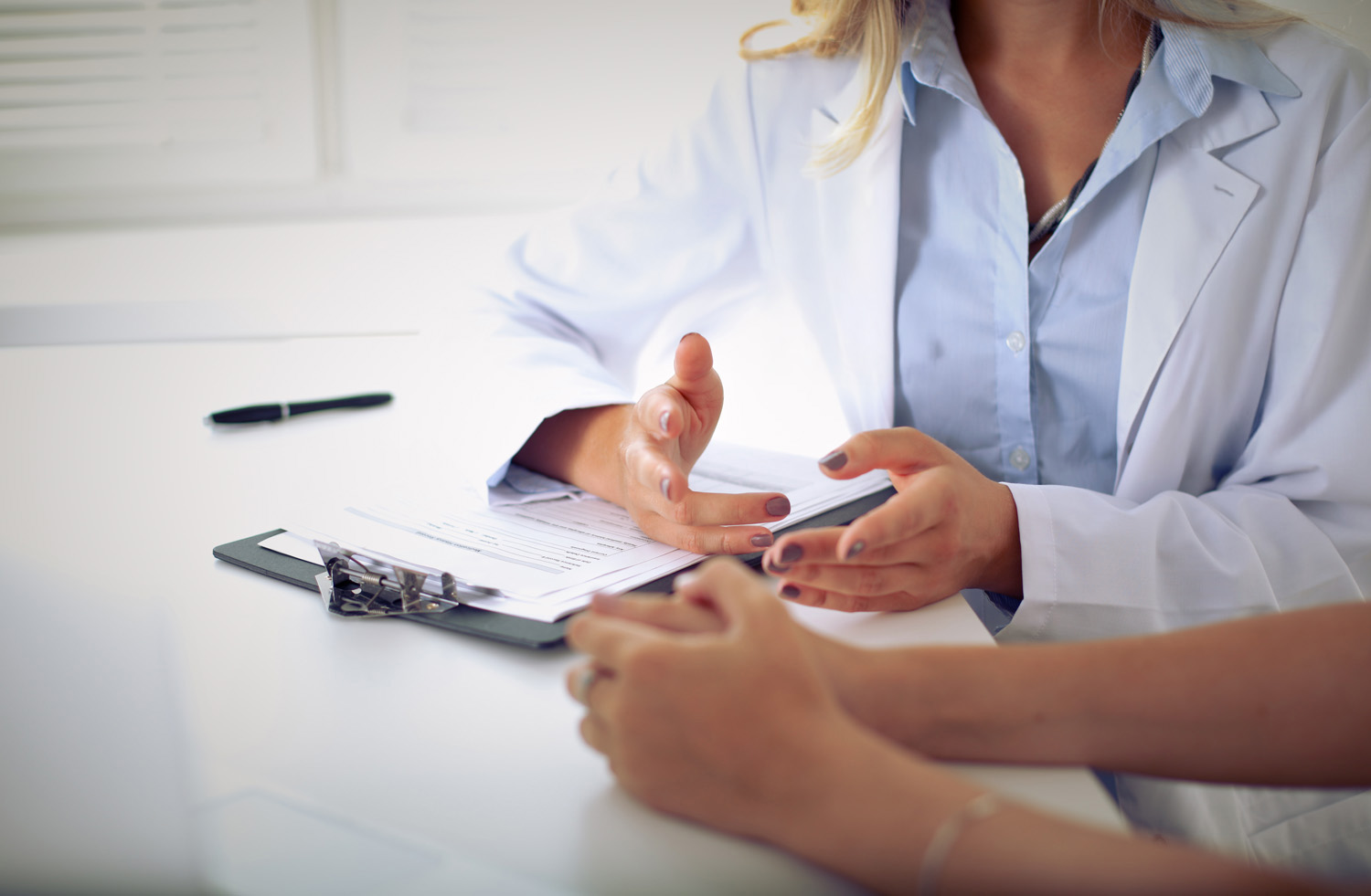 female pharmacies conducting a review with patient