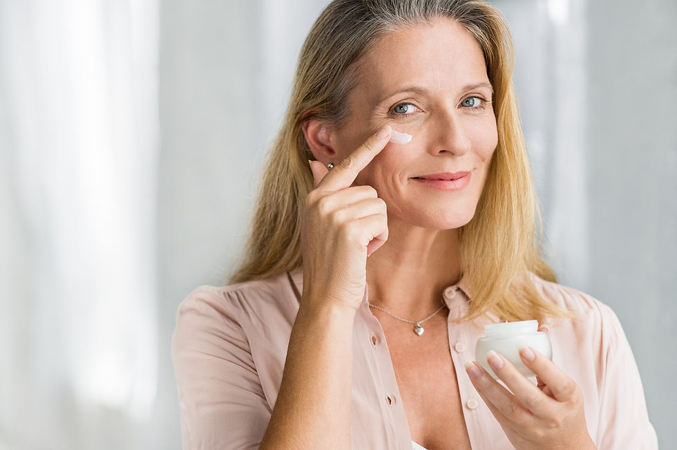 older woman putting on face cream